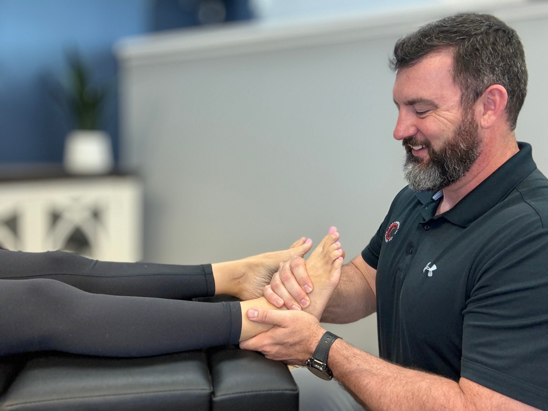 Dr. Rhett King adjusting a patient's hand at King Chiropractic in Wilmington NC