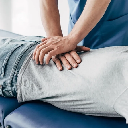 Chiropractor performing a back adjustment.
