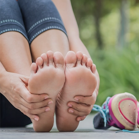 A person holding their feet.
