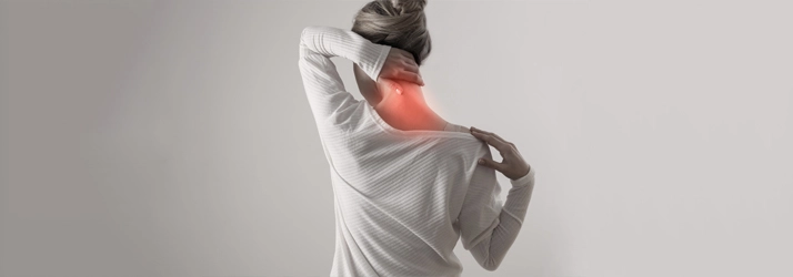 Chiropractic Wilmington NC Neck Pain A woman holding her neck in pain.