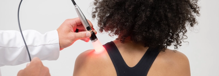 Chiropractic Wilmington NC Shoulder Laser Therapy A person receiving laser therapy on their shoulder.